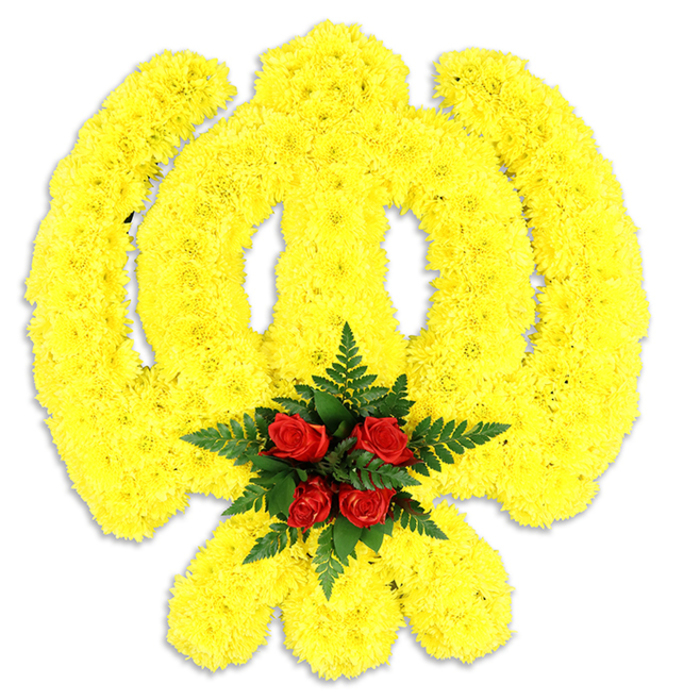 Dominating a pristine white field, this large floral Khanda reads as both a devotional symbol and a masterclass in shape-making: thousands of compact yellow chrysanthemum heads have been set in tight formation to outline the circular chakram, the central double-edged khanda blade and the two crossing kirpans with precise, flowing curves. The yellow surface is rich and textured, the tiny flowers arranged so closely that light skims the petals and creates a soft, tactile relief across the emblem's planes. At the exact centre of the composition a concentrated grouping of deep red roses-five to six buds-forms an intentional counterpoint; the roses are cupped by dark green fern leaves that add depth and a cool, architectural frame to the scarlet focal point. A delicate grey shadow beneath the tribute anchors it to the white background and hints at the piece's physical scale, suggesting it could be displayed upright at a memorial or laid gently on a ceremonial table. The floral scent is subtle: chrysanthemum freshness backed by the mellow perfume of roses and the green, almost earthy whisper of ferns. Crafted with thoughtful reverence for Sikh symbolism and refined floristry technique, this wreath-like construction conveys respect and continuity, suitable for services and cultural events in and around Ickenham, from Ickenham High Road gatherings to commemorations near Swakeleys Park. The overall mood is calm and honouring, the colour contrast intentionally chosen to convey warmth, remembrance and steadfast devotion.